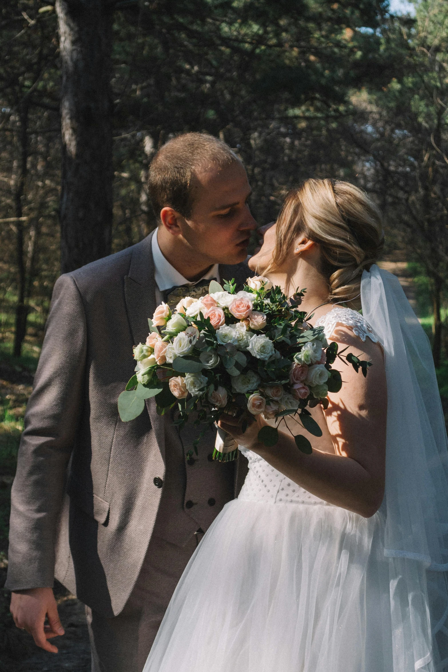 a bride kisses her groom as they kiss