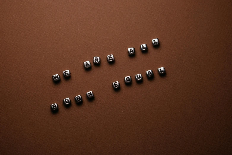 a brown table with small, square objects in them