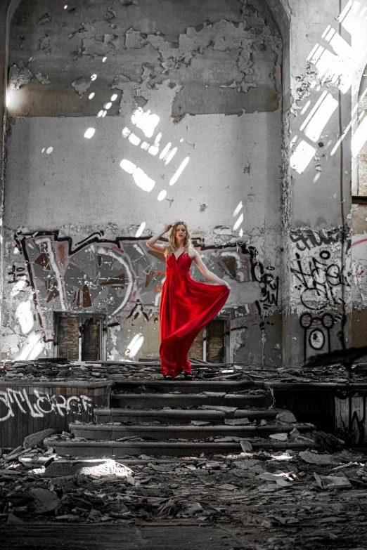 a girl in a red dress in the midst of graffiti