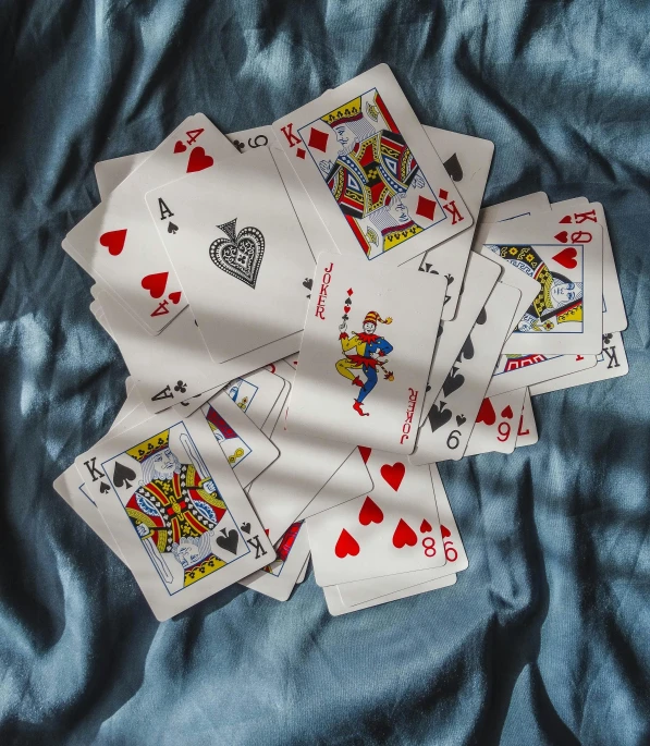 four cards that are laying down on a blue sheet