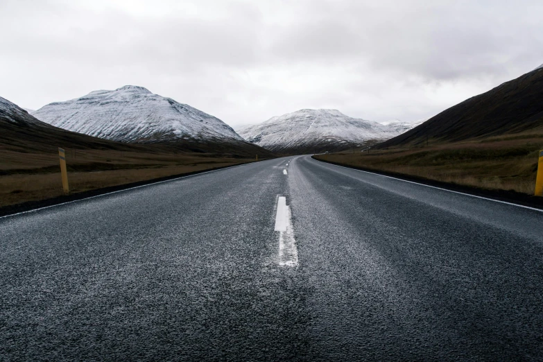 the road is empty with very little snow