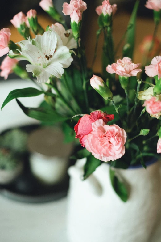 some very pretty flowers in a white vase