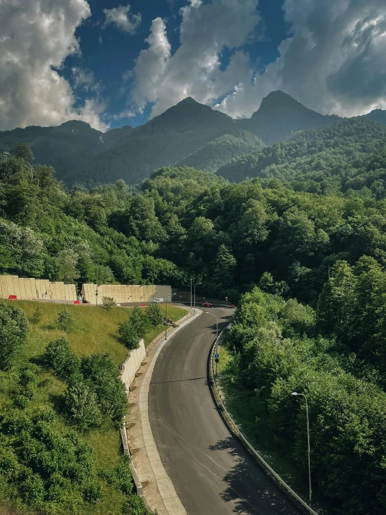 the view from above looking down a road in the mountains