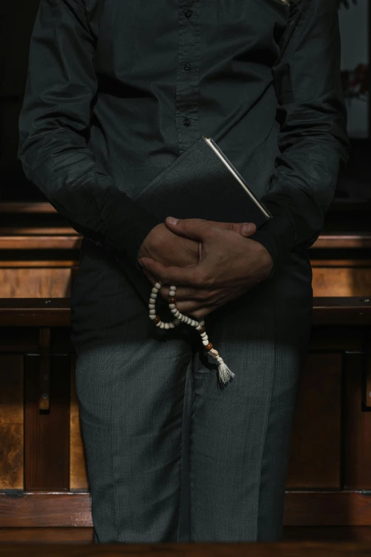 a man holds some beads in his hands