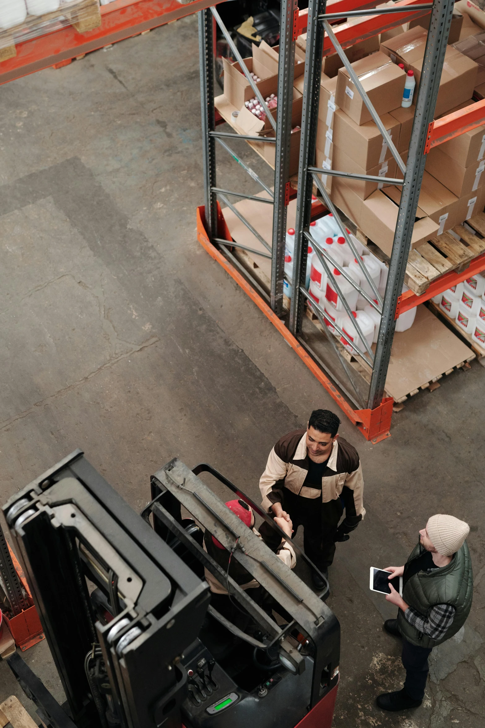 three people standing in front of a large crate