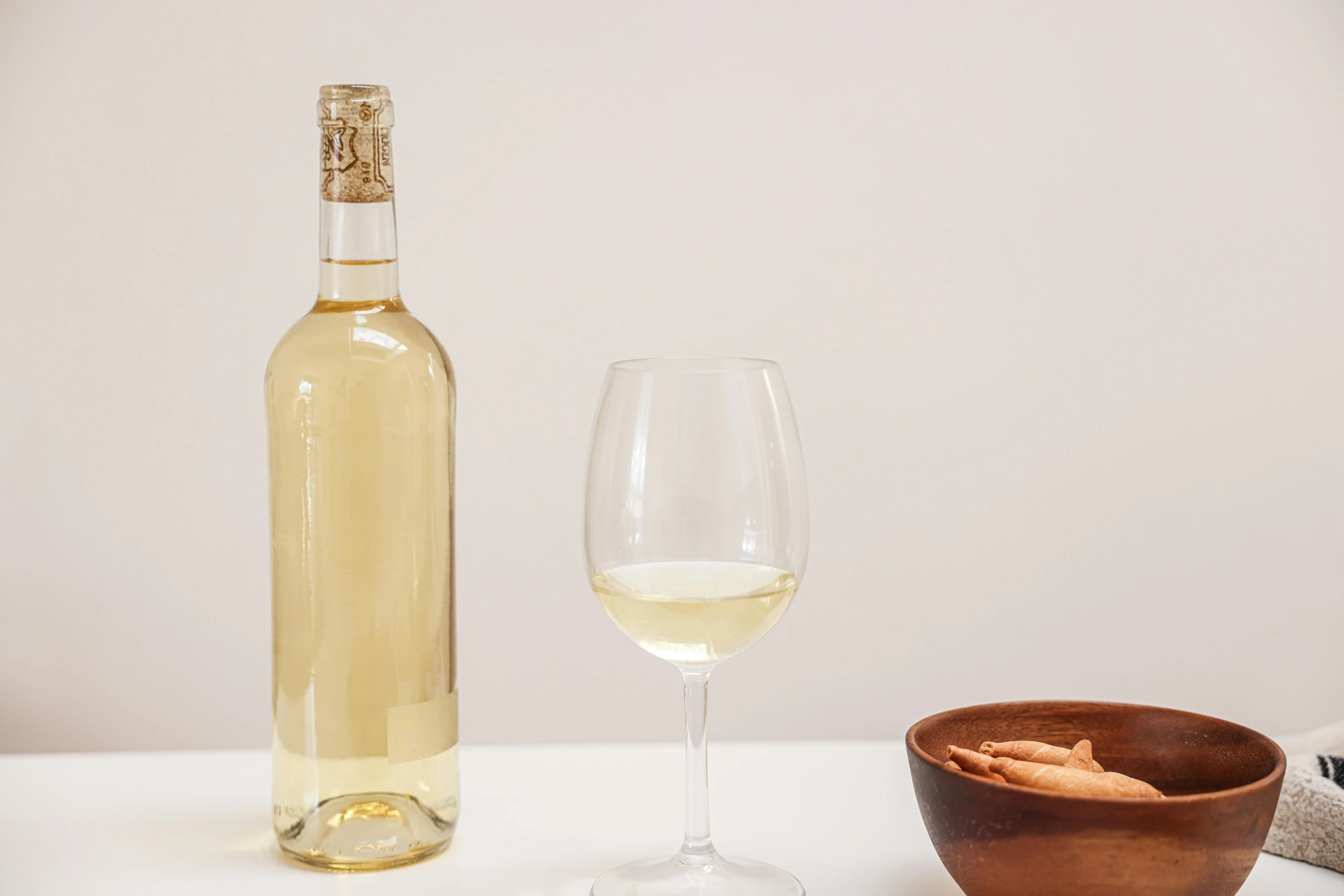 a glass and wine bottle on a table