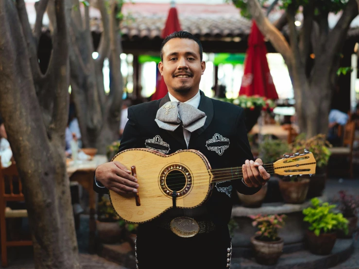 man in a mexican - themed restaurant playing a guitar