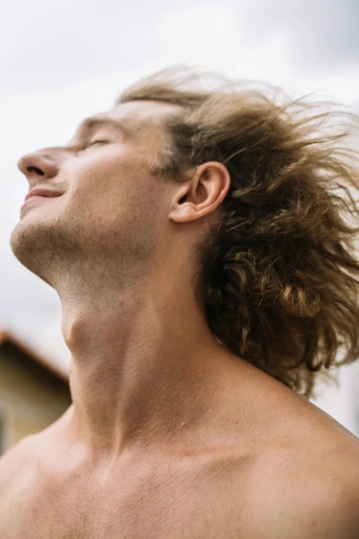 a man with a long beard standing and looking up