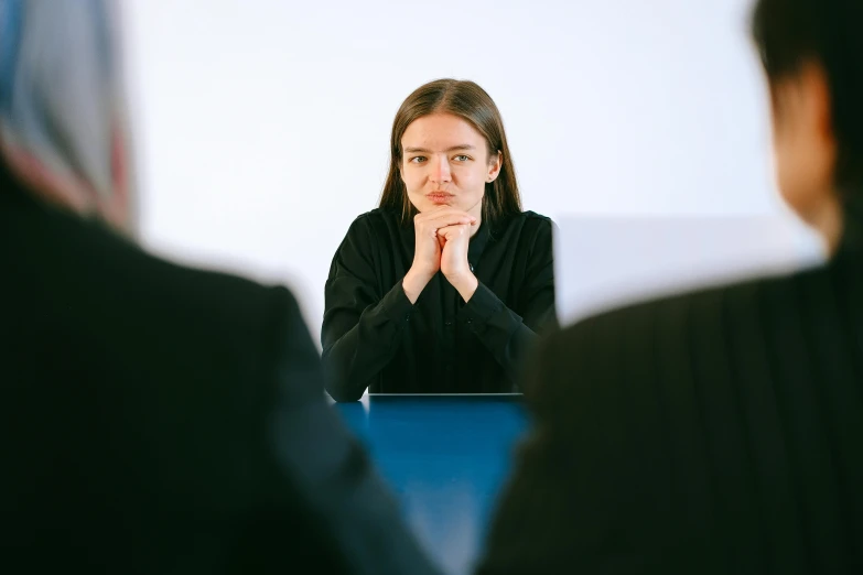 a woman is sitting and watching soing in front of her