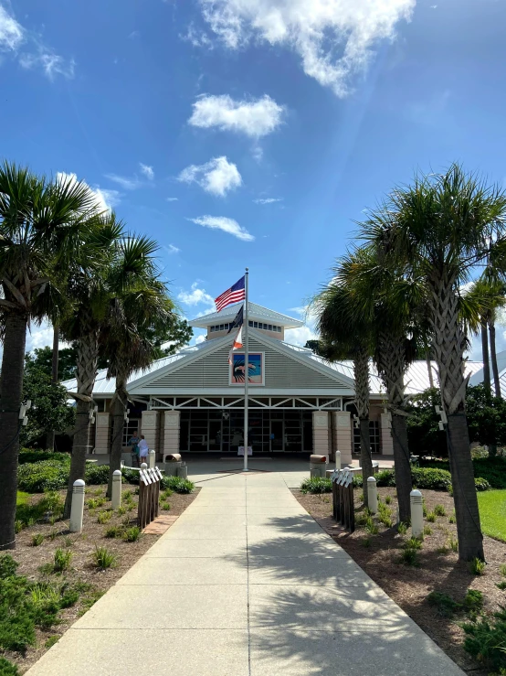 a building is surrounded by palm trees and shrubs