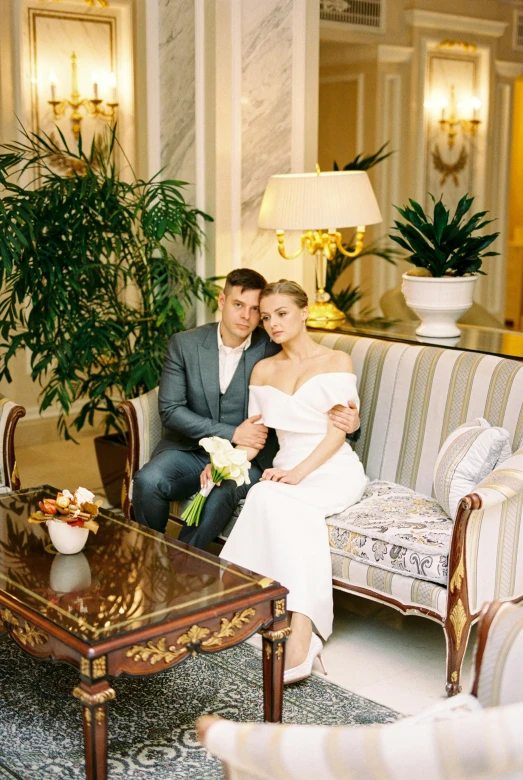 a bride and groom posing for a po in the lobby