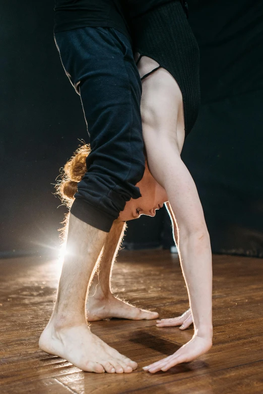 a dancer standing upside down with her feet up