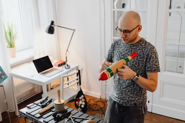 a man standing in a room with his toy