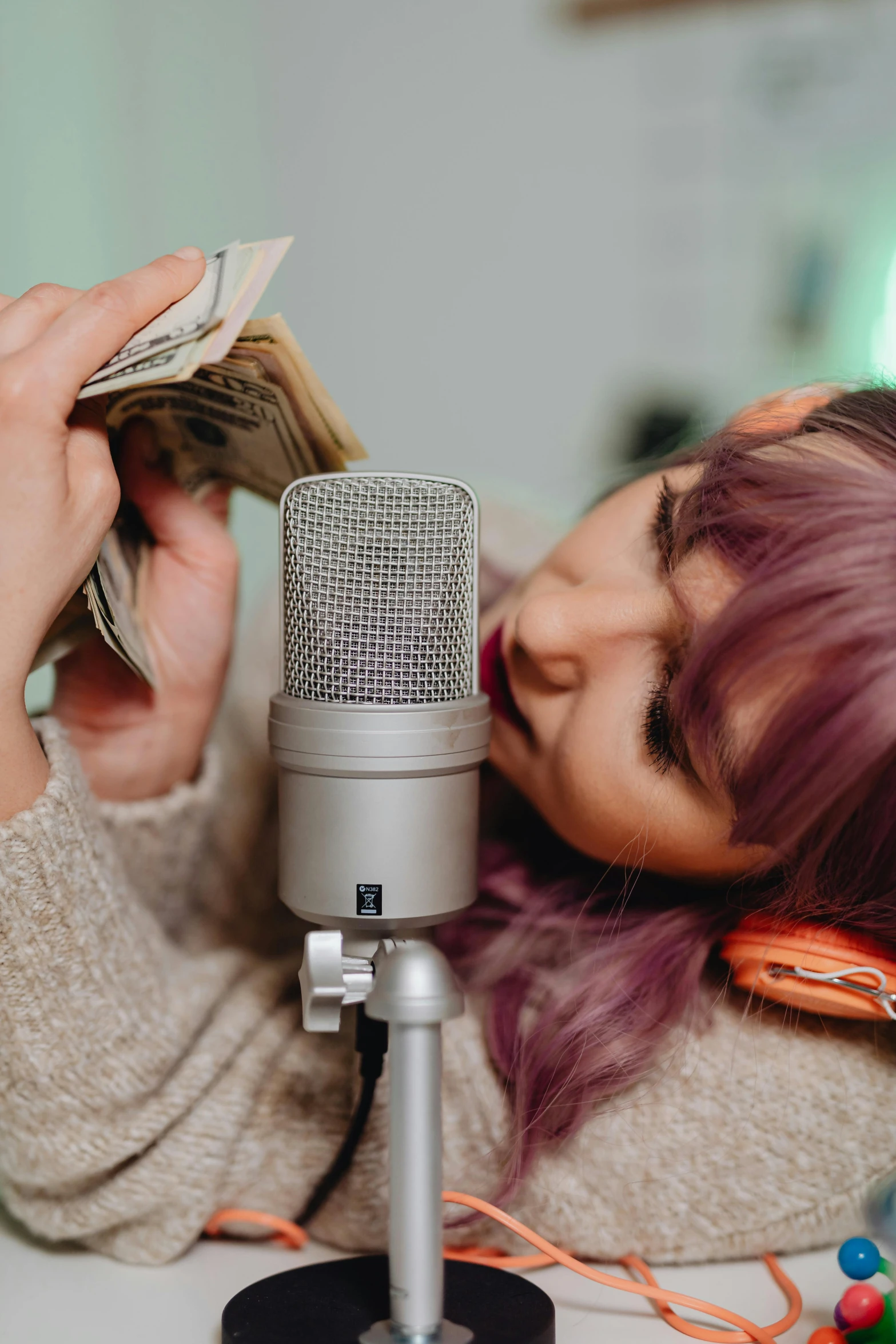 a woman lying her head on a microphone