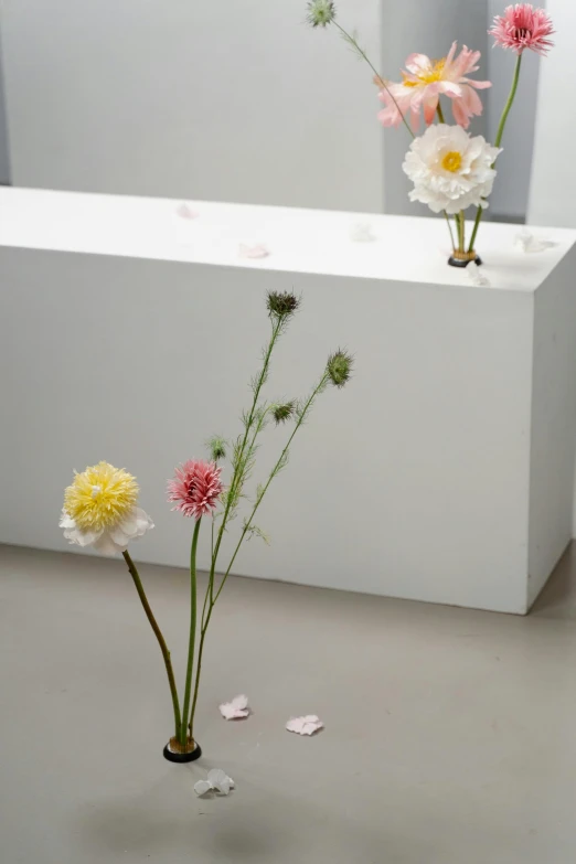 three vases of flowers on a table in a room