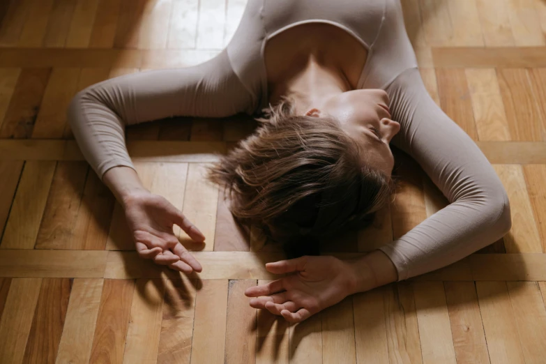 a woman is on the floor doing yoga