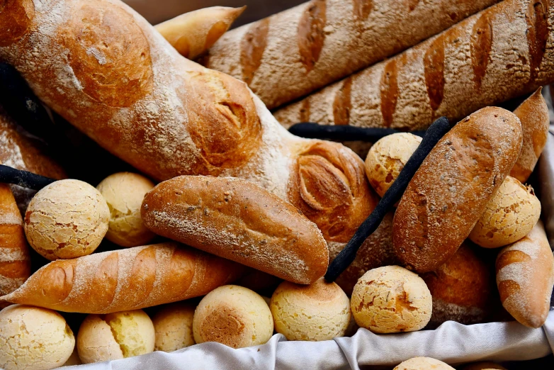 loaves of breads and rolls with powdered sugar