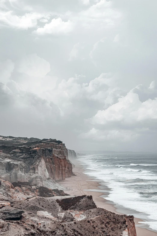 the water is calm with waves near a mountain