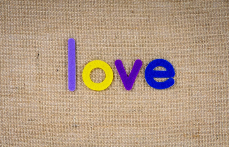 love spelled out on a beige canvas background