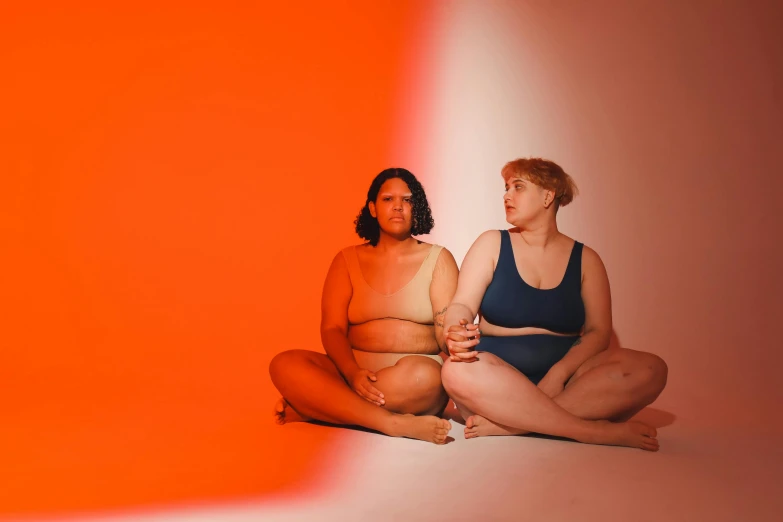 two women sitting in the middle of a po