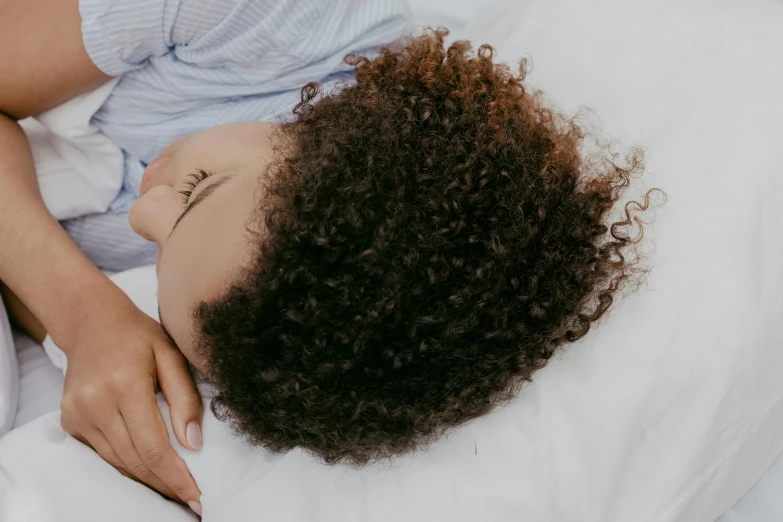 a woman with short hair on a white sheet