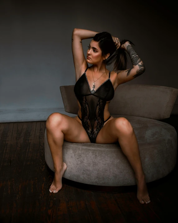 woman in see through lingerie sitting on couch