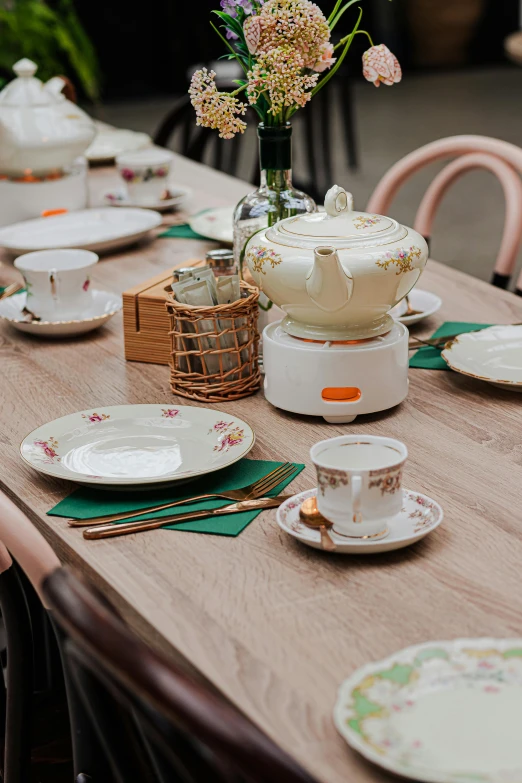 dinner table set with plates and dishes, pitcher on top