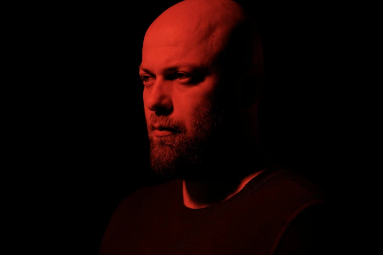 a man with his face obscured by red filter