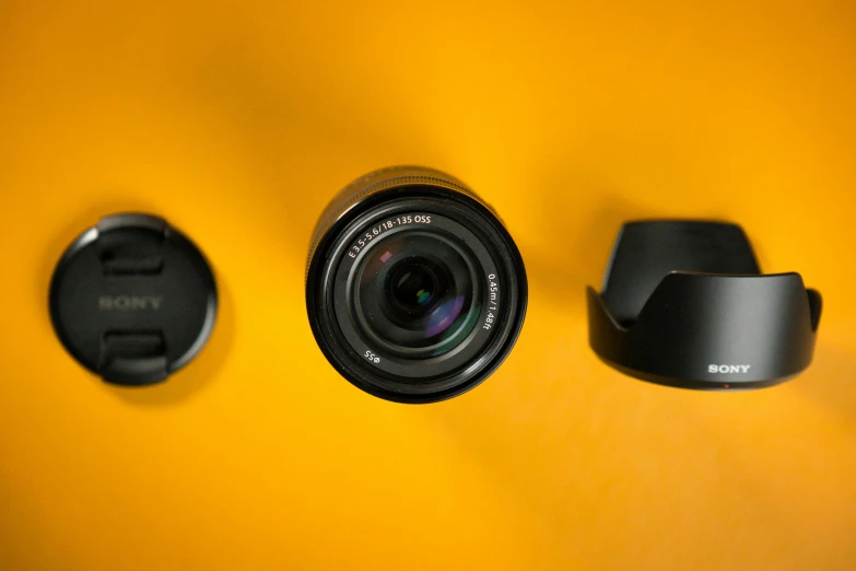 a view of a camera and two other things on a yellow wall