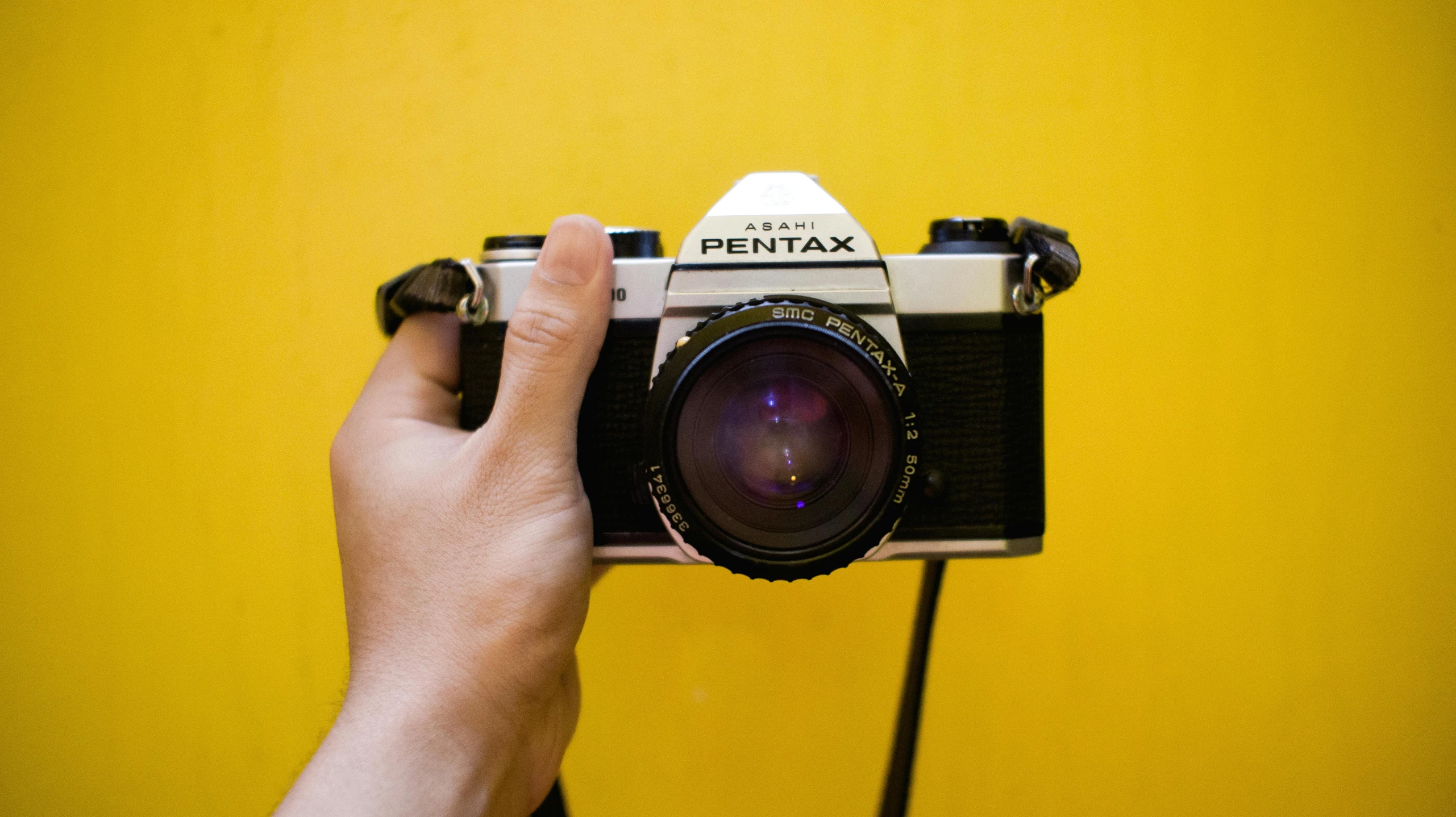 a person holds a camera up to the side