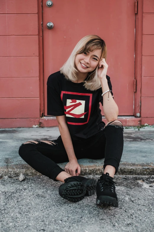 a blonde lady posing for the camera with her shoe