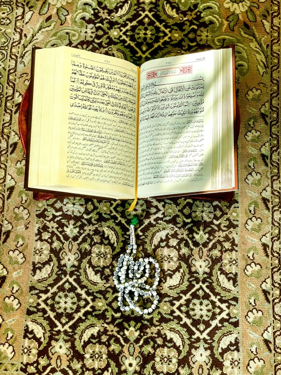 an open book sitting on top of a carpet