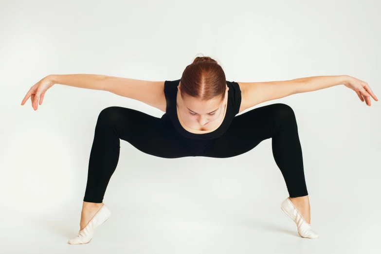 woman in black shirt doing a yoga pose