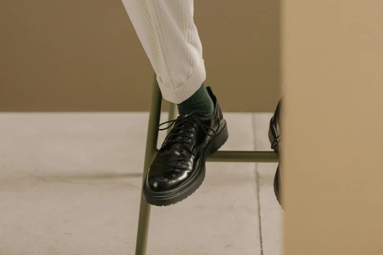 the feet of a person with green socks and black sneakers