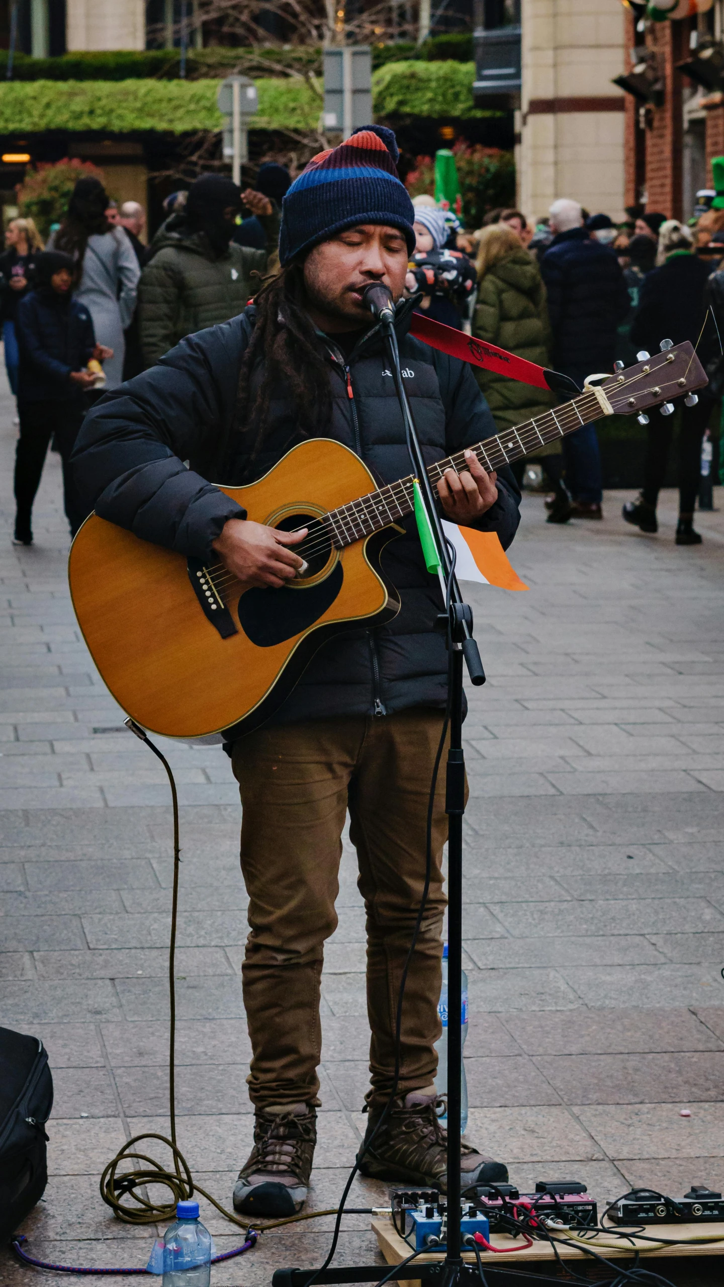 the man is playing the guitar while singing