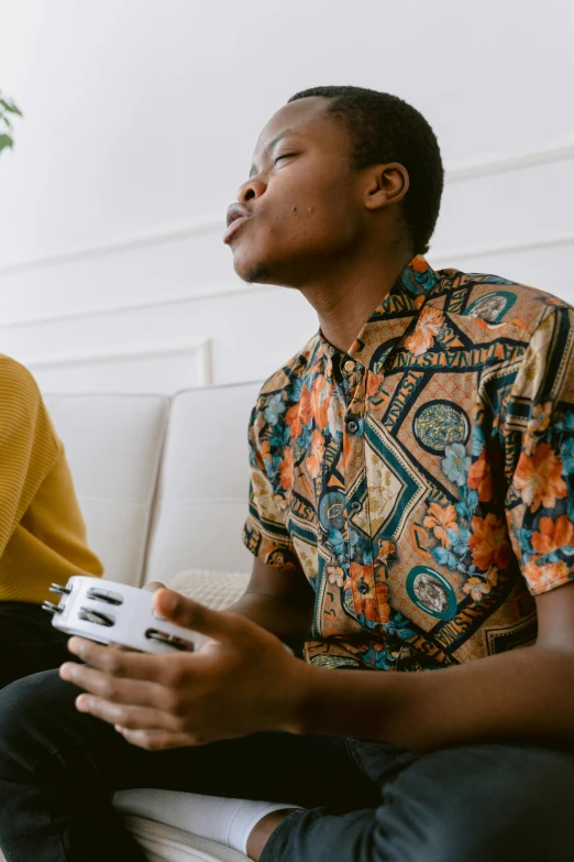 a man on a couch holding a game controller