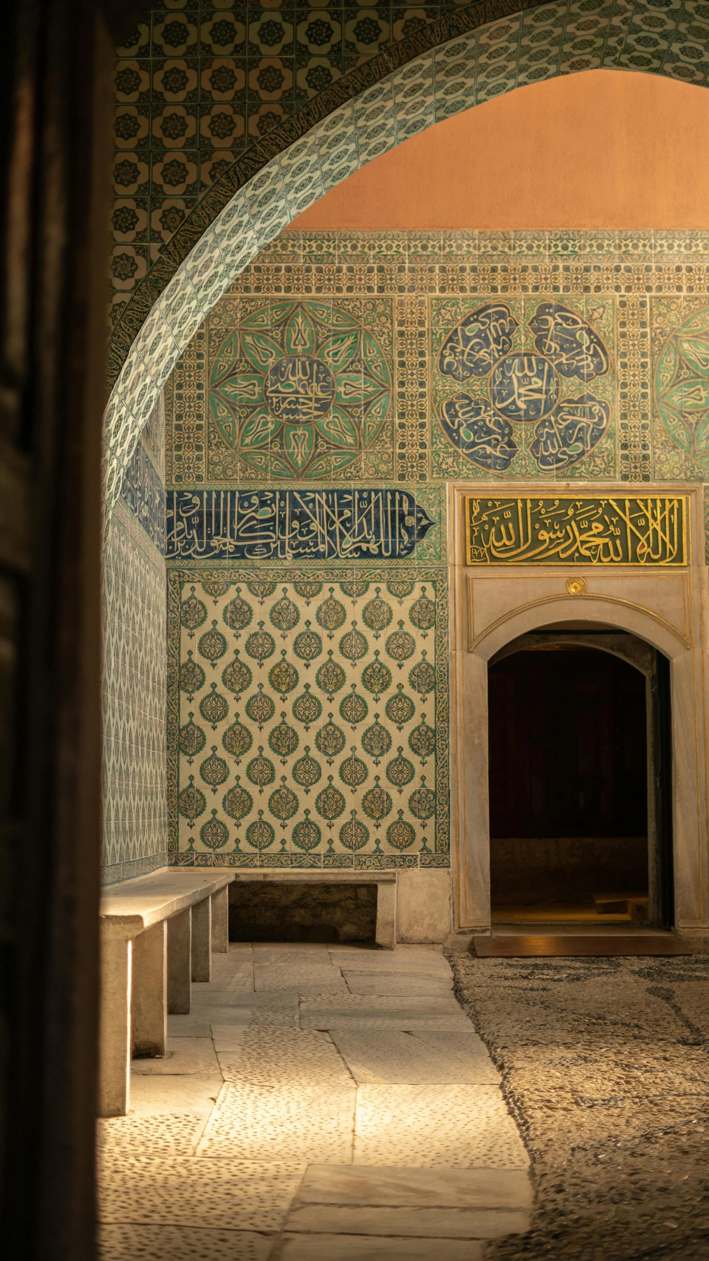 an ornate tiled wall inside of a building