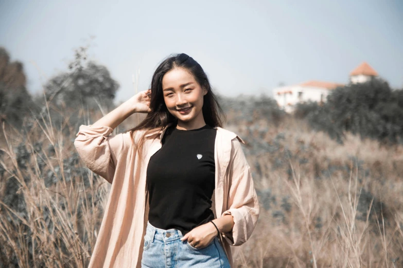 a woman is smiling and wearing high - rise denim