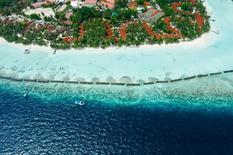 a po of the beach with a boat and resort