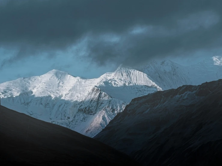 a large mountain with many snow covered mountains