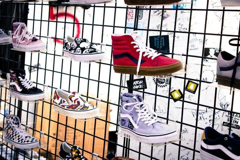 a display in a room with shoes on each shelf