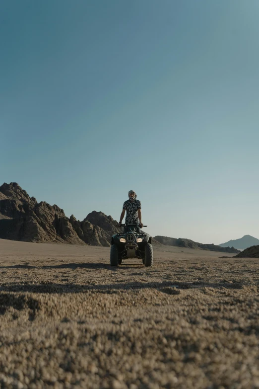 a person riding a four wheeler across a desert