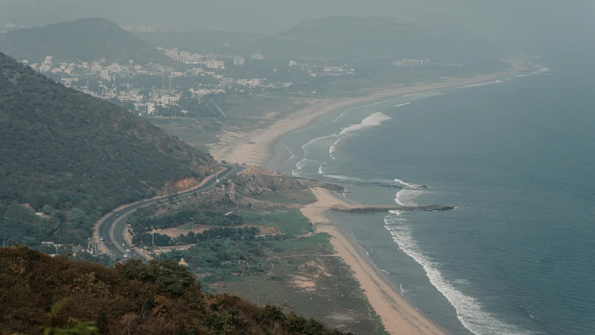 an ocean view with the town on the left side and beach at the top