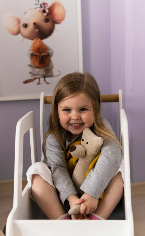 a little girl is sitting in the toddler seat