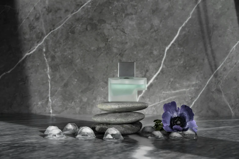 a spa with rocks, flowers and soap next to it