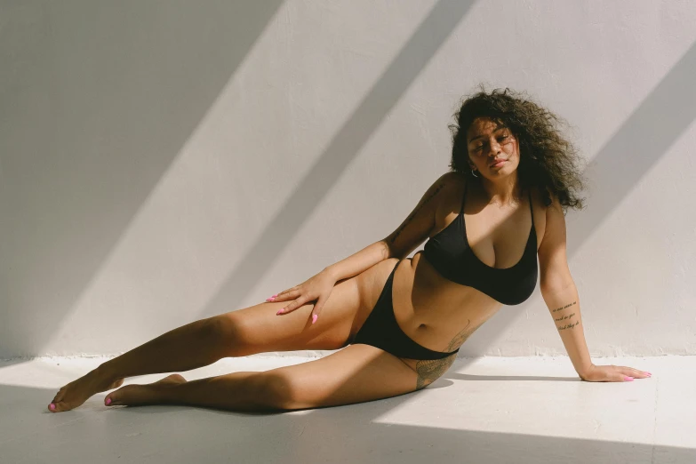 a woman in a bikini posing with a white background