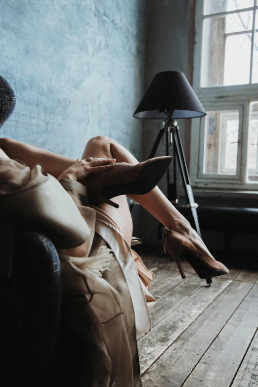 a women laying in a chair with her legs up