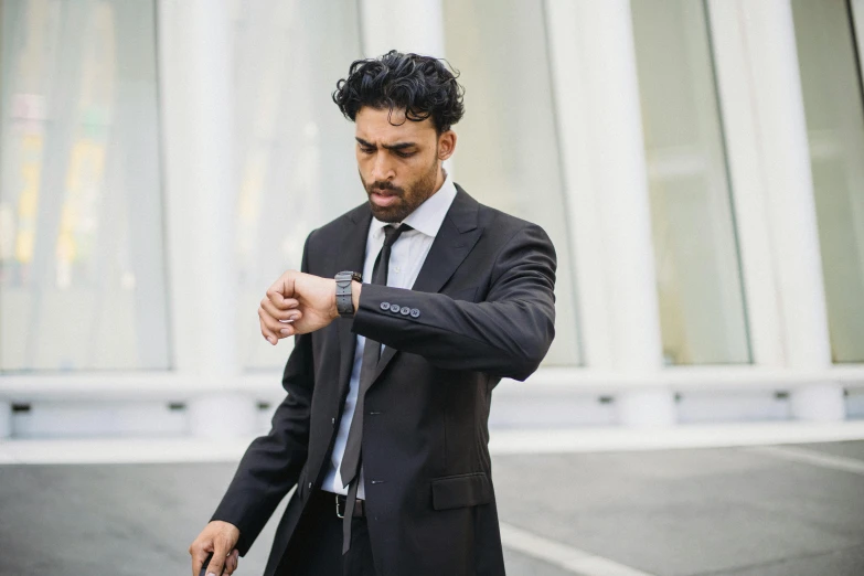 a man standing outside holding a suit case