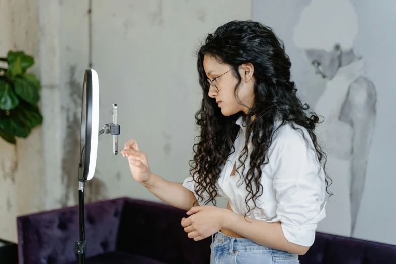 a woman is holding up a camera to take a picture