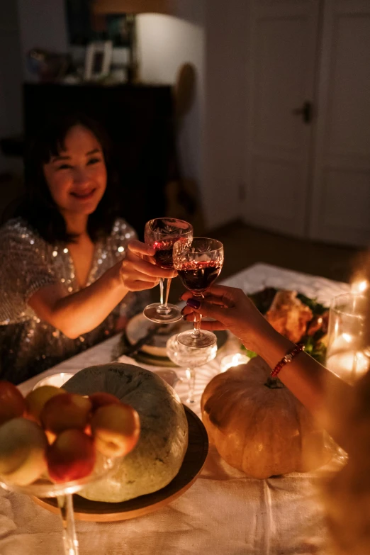 woman at table with wine glasses being toasted by the woman